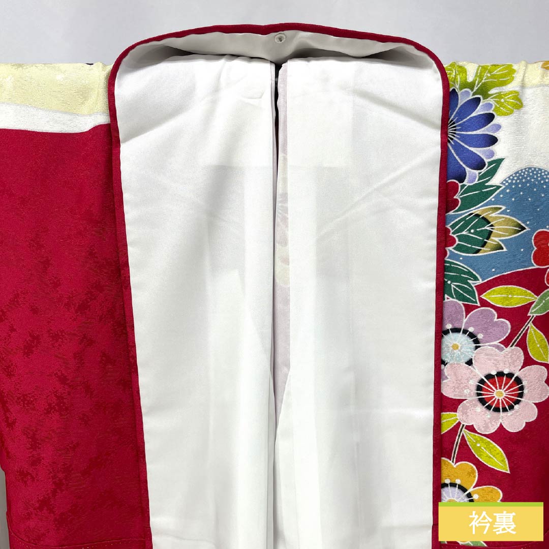 Furisode (long-sleeved kimono) made of pure silk, S rank, length 166.5cm, sleeve length 65.5cm, crimson (shinkuiro) color, featuring auspicious motifs of peonies, chrysanthemums, plum blossoms, and cherry blossoms in red tones. Product code: 1113002212512
